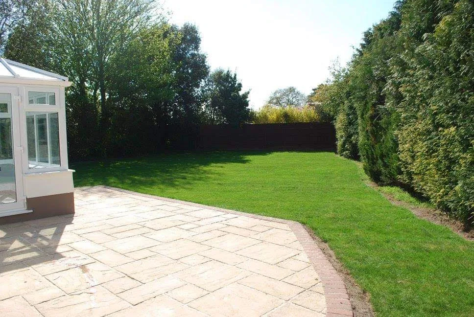 The back garden after: a new lawn and a cleaned patio