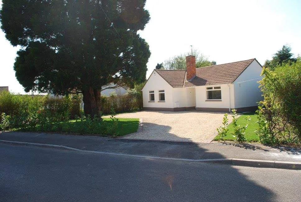 The same bungalow after: painted, a new drive and a trimmed garden