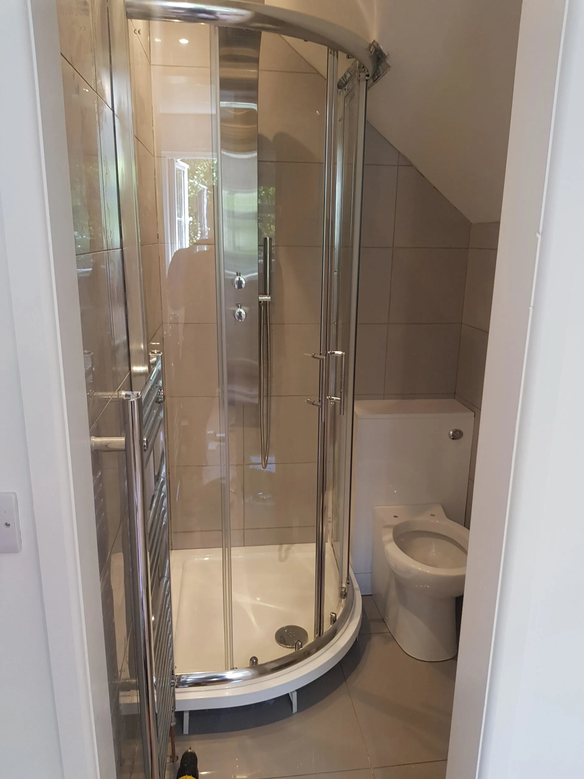 A quadrant shower under a sloped ceiling